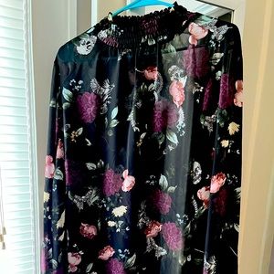 Sheer blouse with flower and skull detail.